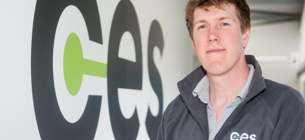 CES managing director Joe Collison stands in front of the company logo at CES HQ.